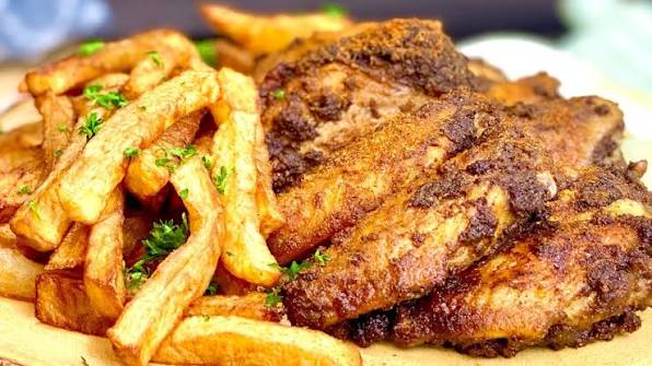 Suya-spiced wings served with fries